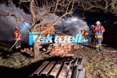 Erneut brennender Holzstapel, die Feuerwehr kann den Stapel, der zum Teil in Vollbrand stand, zügig ablöschen